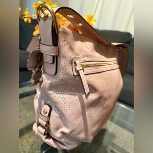 The Coach L1282-F19407 is a Signature Perforated Leather
North South Duffle bag